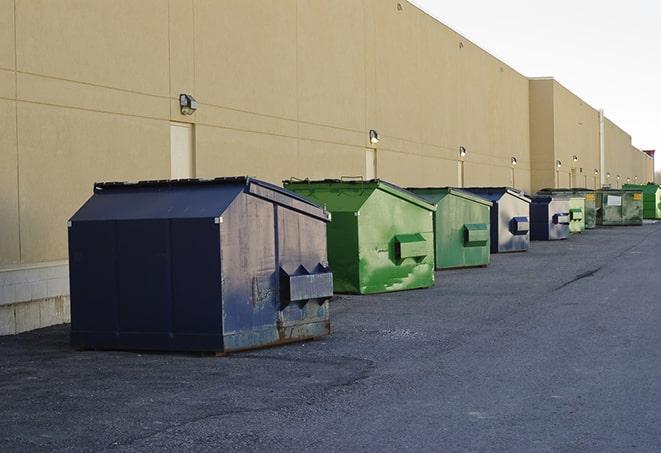 large construction waste containers in a row at a job site in Bedford TX